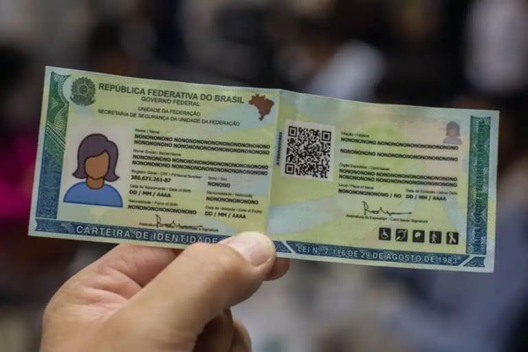 uma carteira de identidade brasileira com informações em branco, exibida por uma pessoa. O alerta do Governo estadual é sobre atualização de documentos para servidores inativos e aposentados até 30 de abril.